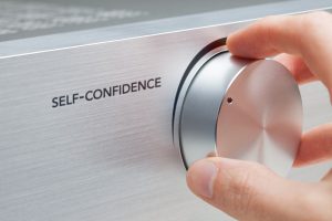 Self-confidence improvement concept. Coach or mentor help to increase self-confidence. Knob with hand representing growth.